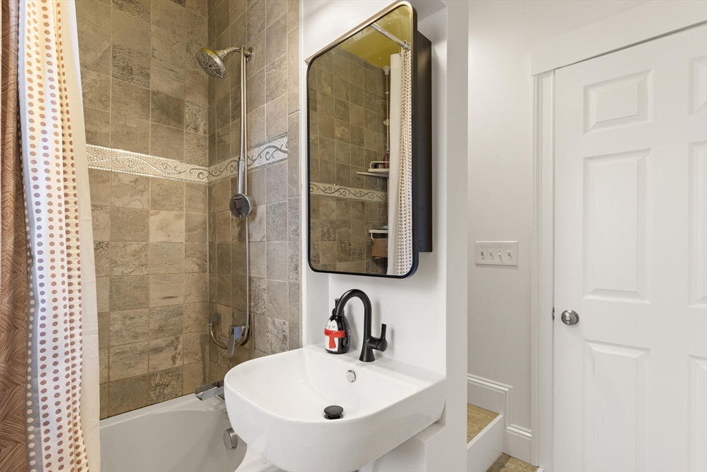 222 Lawrence Street Haverhill, MA 01830 - Photo 15 of 32 a bathroom with a sink and a mirror