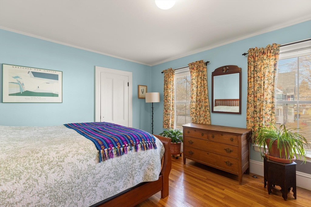 222 Lawrence Street Haverhill, MA 01830 - Photo 18 of 32 a bedroom with a bed table chair and a window