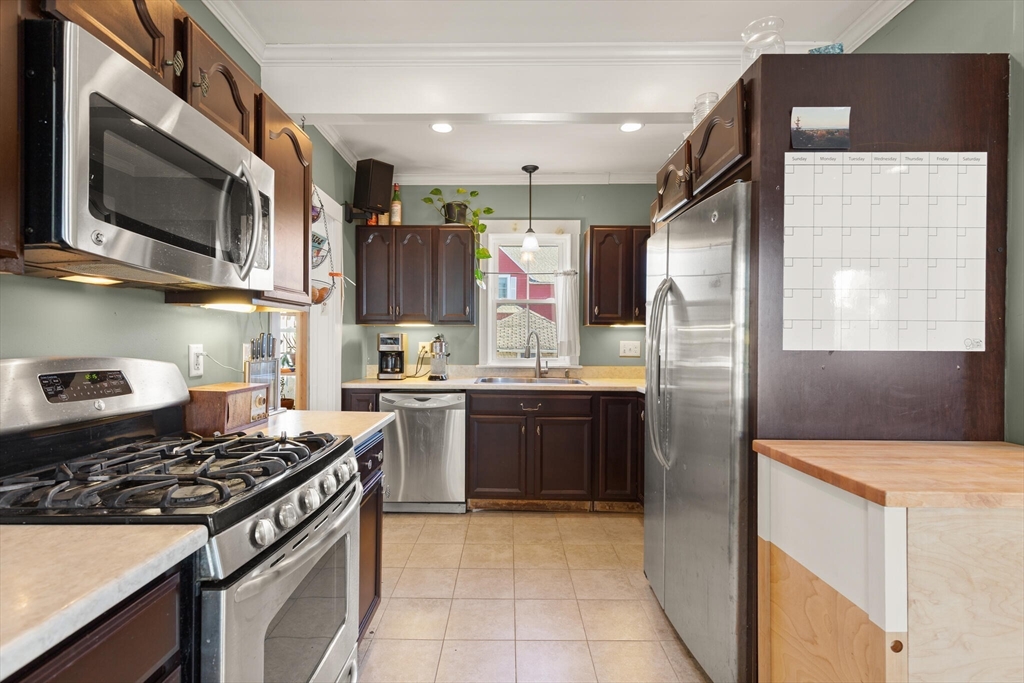 222 Lawrence Street Haverhill, MA 01830 - Photo 8 of 32 a kitchen with stainless steel appliances granite countertop a stove a sink and a refrigerator