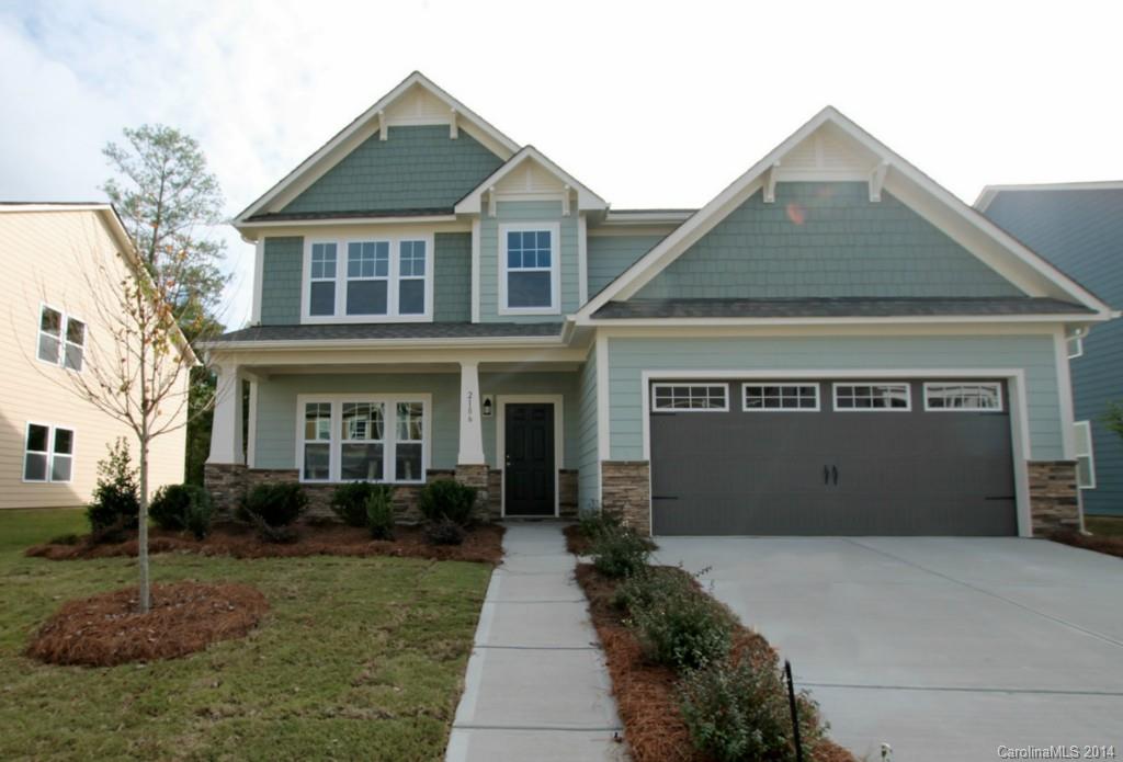 2186 Bluebell Way, Unit 170 Tega Cay, SC 29708 - Photo 1 of 15 a front view of a house with a garden and plants