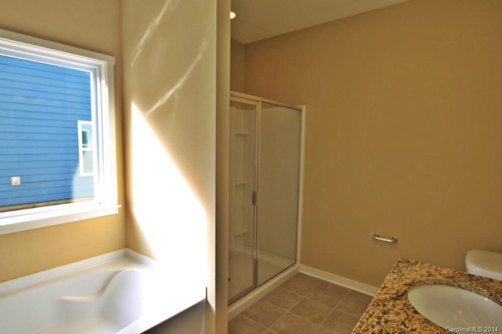 2186 Bluebell Way, Unit 170 Tega Cay, SC 29708 - Photo 11 of 15 a bathroom with a granite countertop sink and a mirror