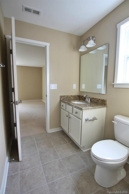 2186 Bluebell Way, Unit 170 Tega Cay, SC 29708 - Photo 13 of 15 a bathroom with a sink toilet and mirror