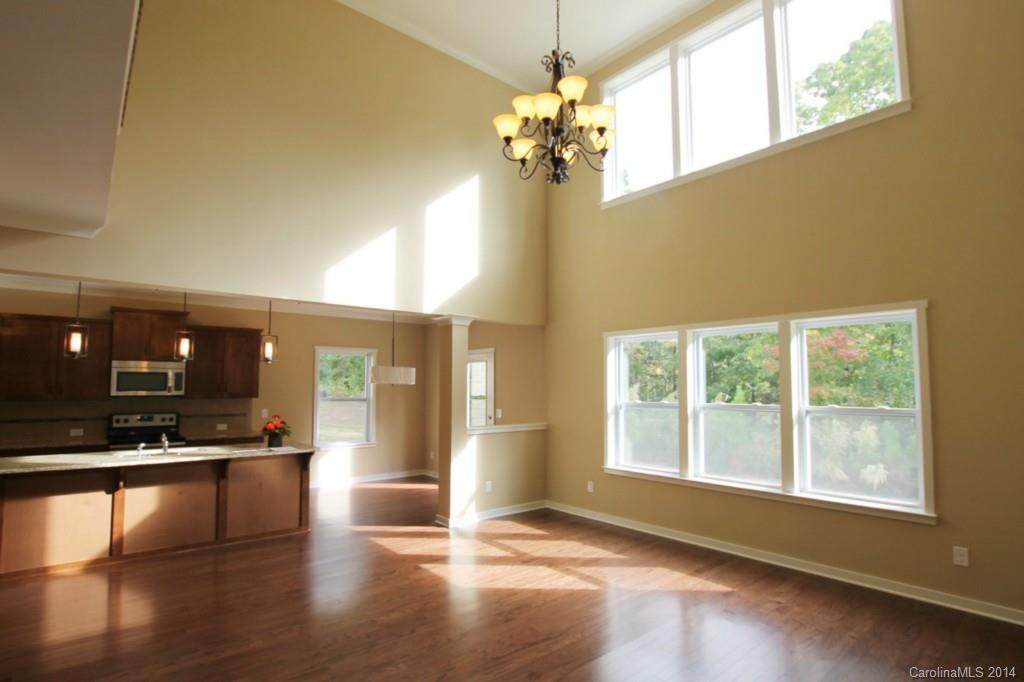 2186 Bluebell Way, Unit 170 Tega Cay, SC 29708 - Photo 7 of 15 an empty room with wooden floor and windows