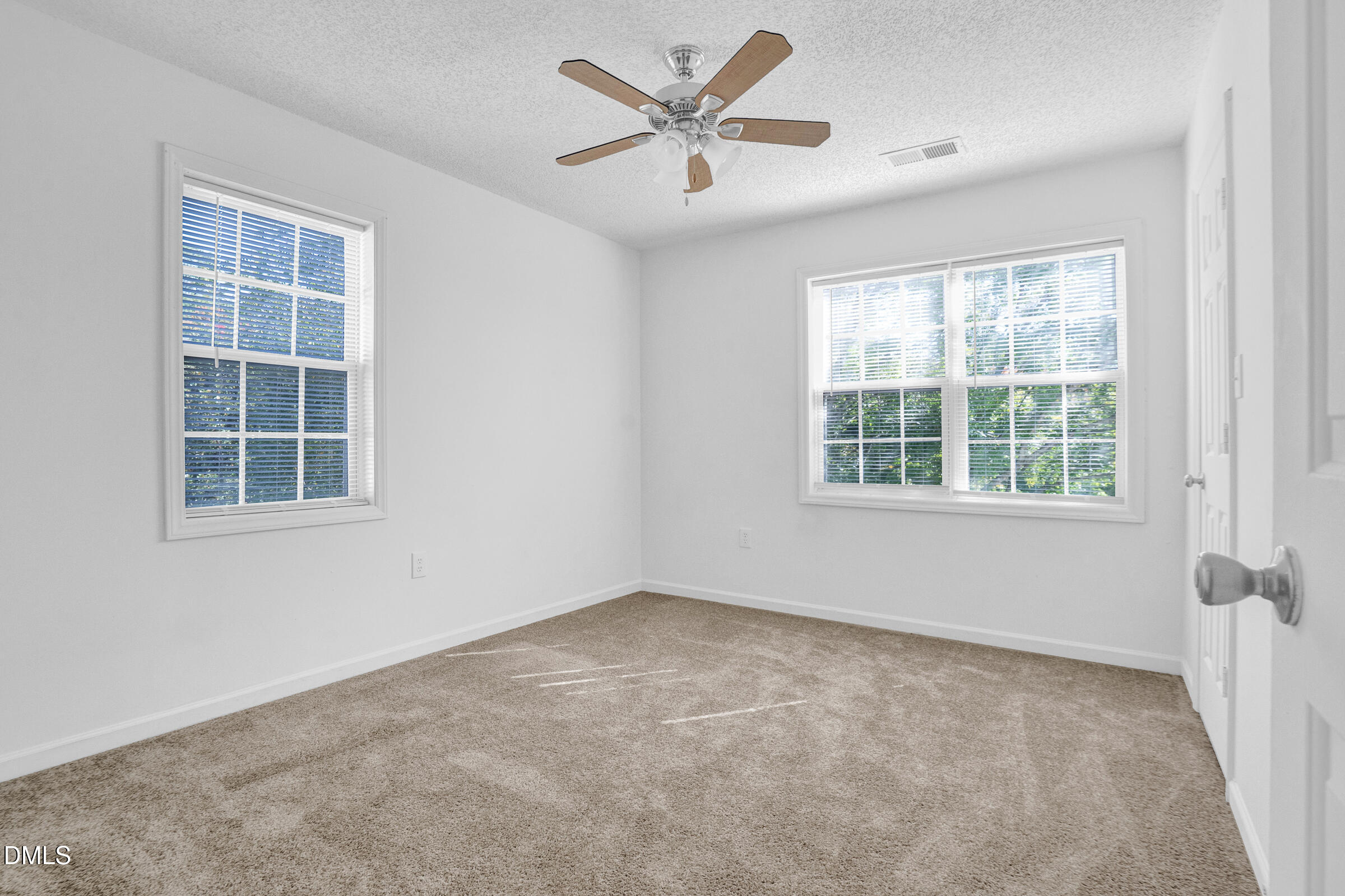 1911 Wolf Tech Lane, Unit 302 Raleigh, NC 27603 - Photo 13 of 20 an empty room with a window and a fan
