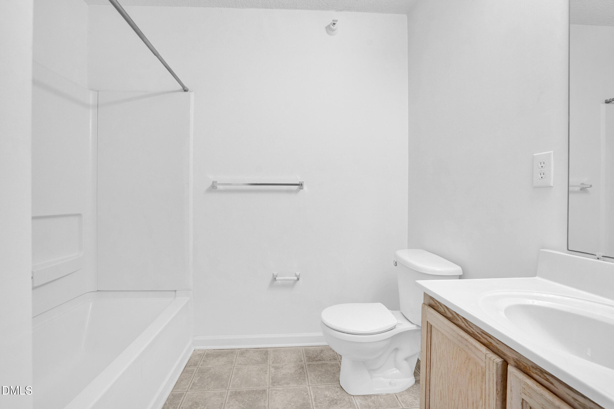 1911 Wolf Tech Lane, Unit 302 Raleigh, NC 27603 - Photo 15 of 20 a white toilet sitting next to a bath tub