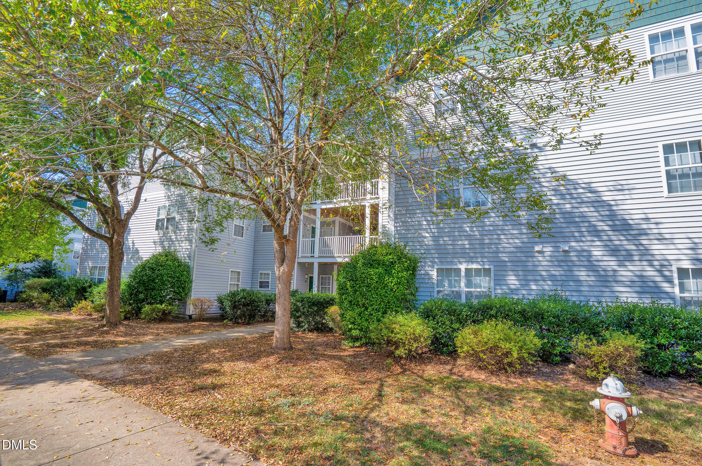 1911 Wolf Tech Lane, Unit 302 Raleigh, NC 27603 - Photo 2 of 20 a view of a brick house next to a road and trees