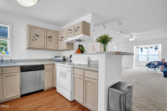 a kitchen with appliances cabinets and a sink