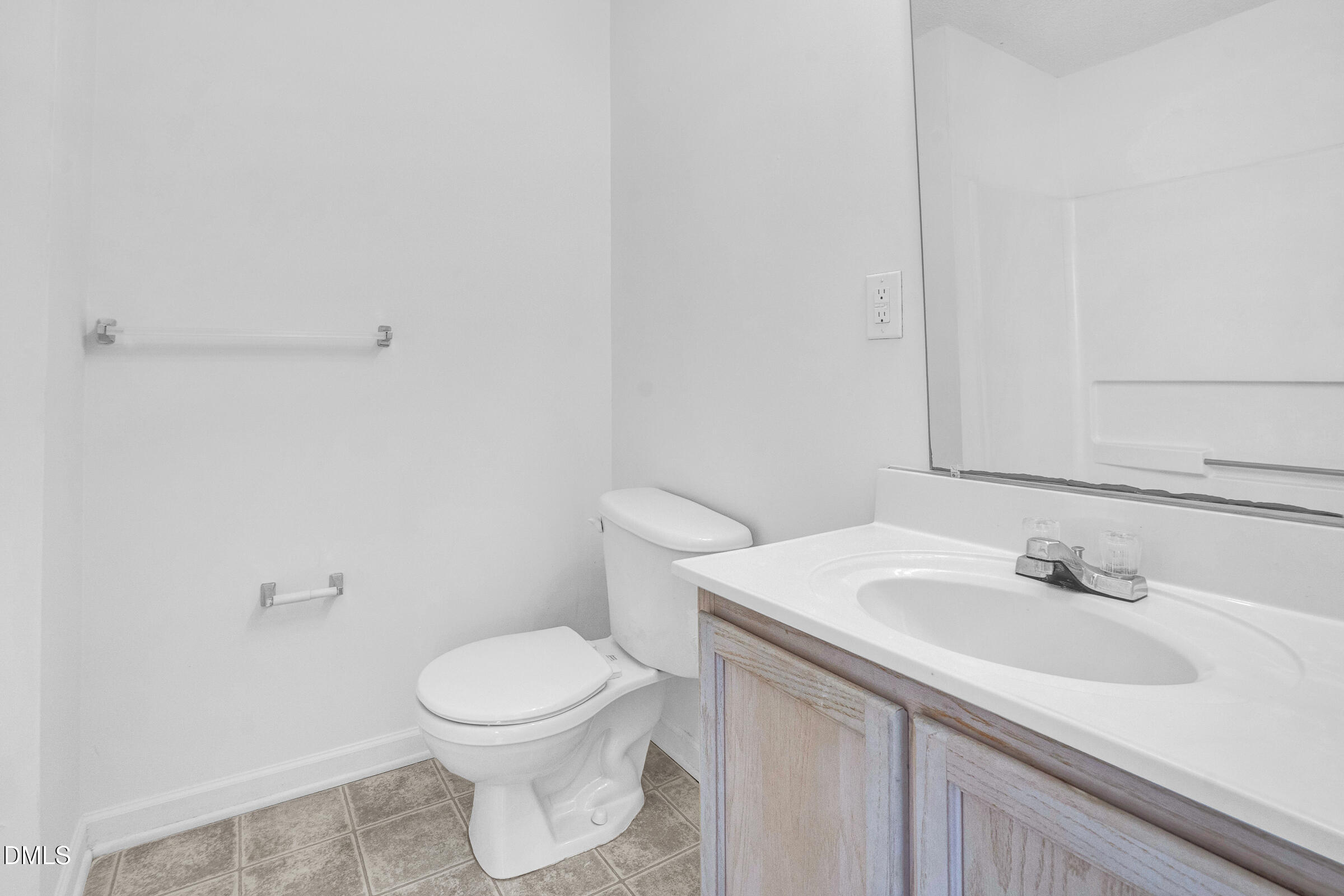 1911 Wolf Tech Lane, Unit 302 Raleigh, NC 27603 - Photo 10 of 20 a bathroom with a sink a toilet and a mirror