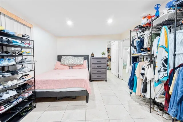 a bedroom with a bed and a book shelf