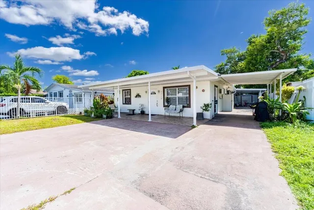 a view of a house with backyard porch and sitting area