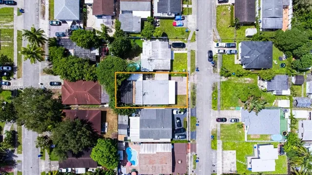 an aerial view of multiple houses with yard