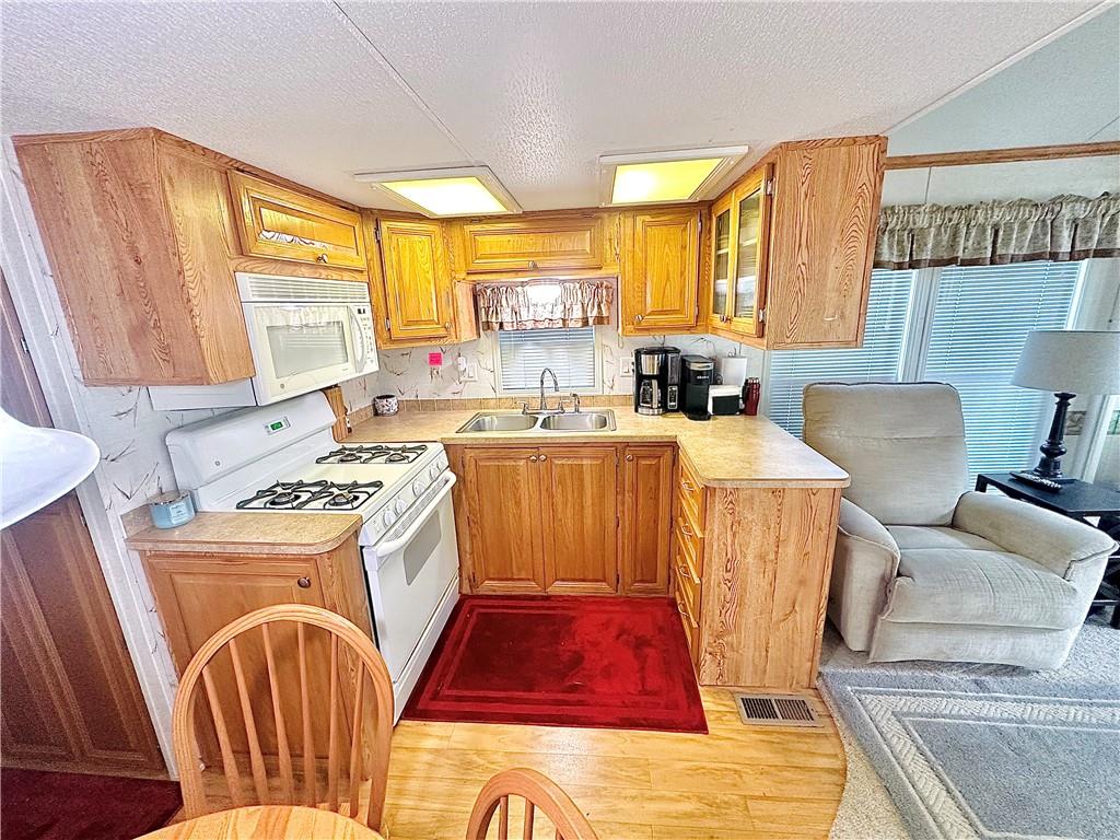 1150 West Park Road Slippery Rock, PA 16057 - Photo 10 of 22 a view of a kitchen with kitchen island a large window a sink and a refrigerator