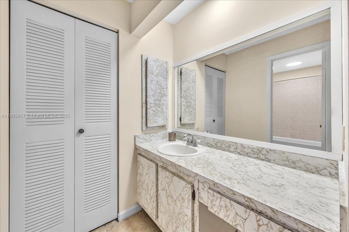3930 Northwest 79th Way Davie, FL 33024 - Photo 17 of 33 a bathroom with a granite countertop sink and a mirror