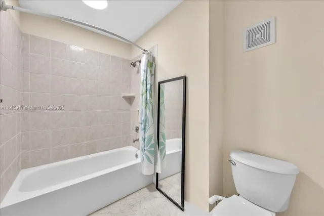 a bathroom with a toilet and a bathtub