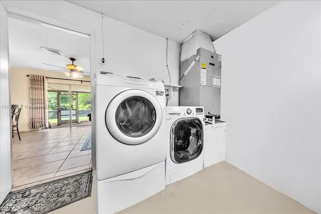 a utility room with sink dryer and washer