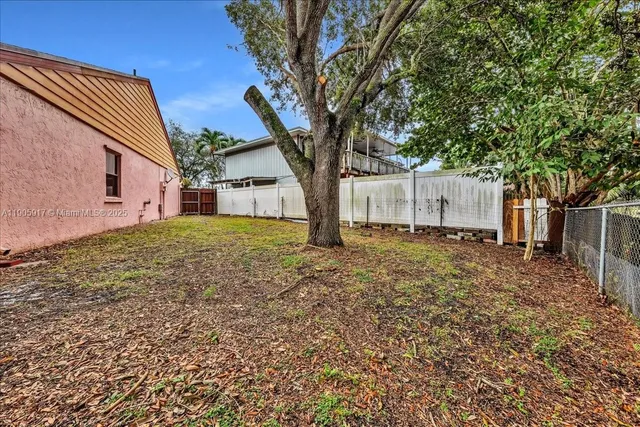 a view of a house with a tree