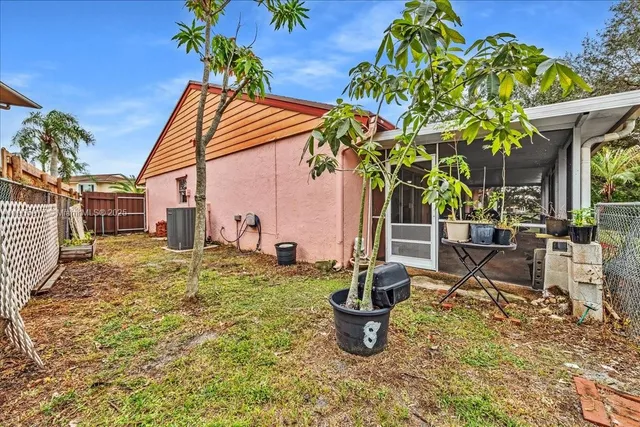 a view of a backyard with table and chairs and potted plants