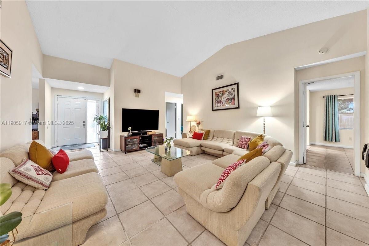 3930 Northwest 79th Way Davie, FL 33024 - Photo 4 of 33 a living room with furniture a flat screen tv and a fireplace