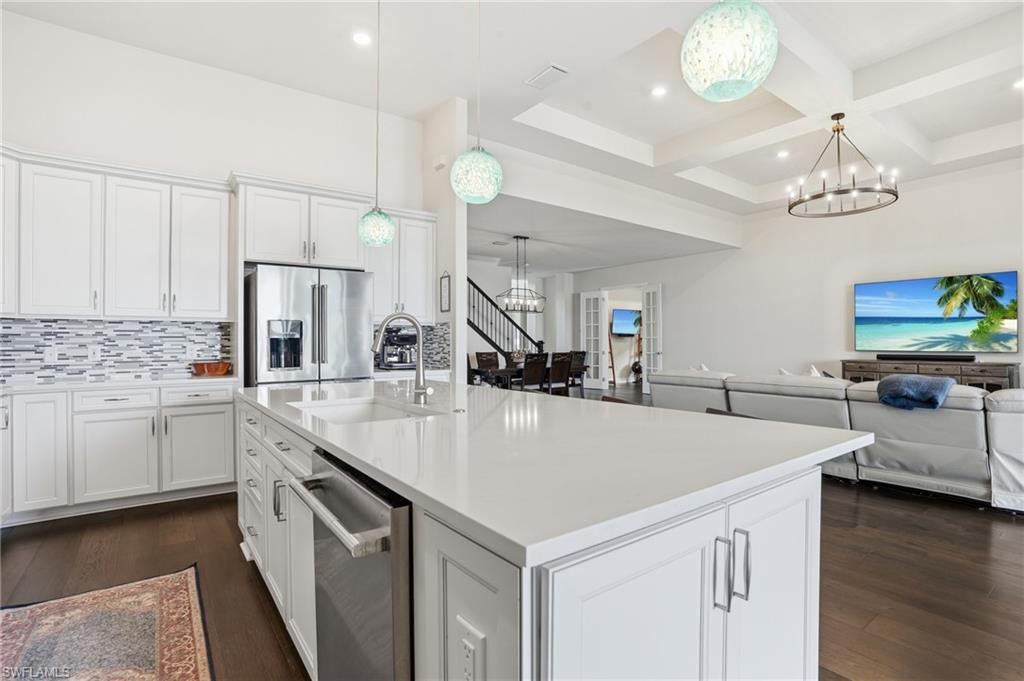 19696 Aqua View Lane Fort Myers, FL 33913 - Photo 13 of 50 a large kitchen with kitchen island a stove a sink a center island and wooden floor