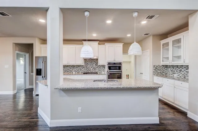 a view of living room with cabinets and wooden floor