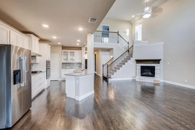 a open kitchen with white cabinets and stainless steel appliances