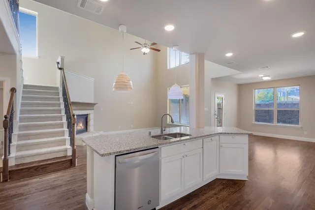 a kitchen with sink cabinets and wooden floor