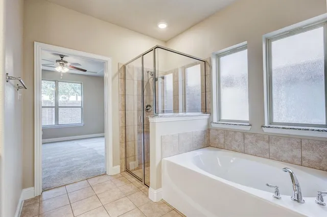 a bathroom with a bathtub and a shower