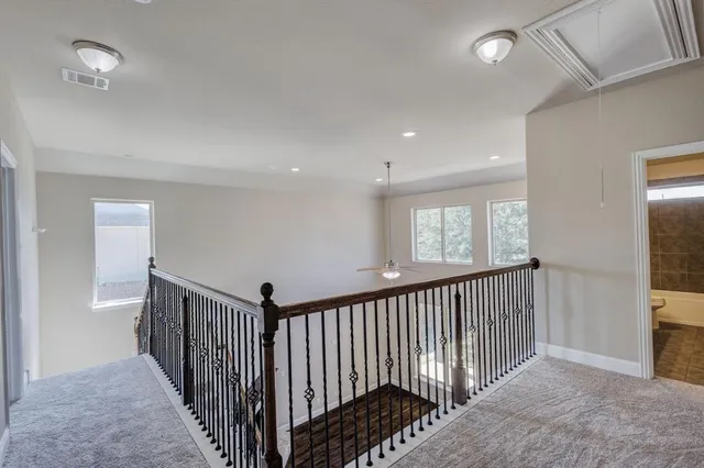 a view of a hallway with windows and stairs