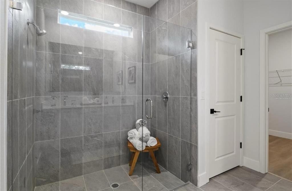 5550 Southwest 107th Street Ocala, FL 34476 - Photo 15 of 17 a bathroom with a mirror and a shower