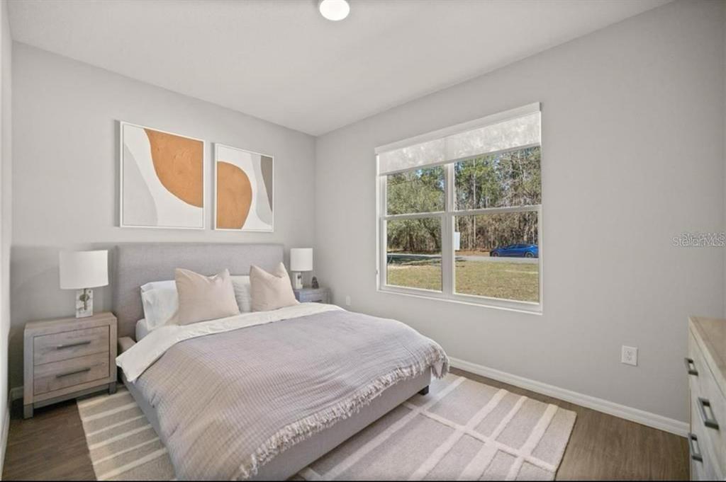 5550 Southwest 107th Street Ocala, FL 34476 - Photo 9 of 17 a bedroom with a bed and a window