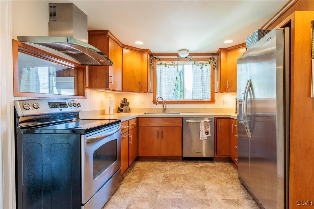615 Alpha Road Wind Gap, PA 18091 - Photo 16 of 38 a kitchen with stainless steel appliances granite countertop a stove a sink and a refrigerator