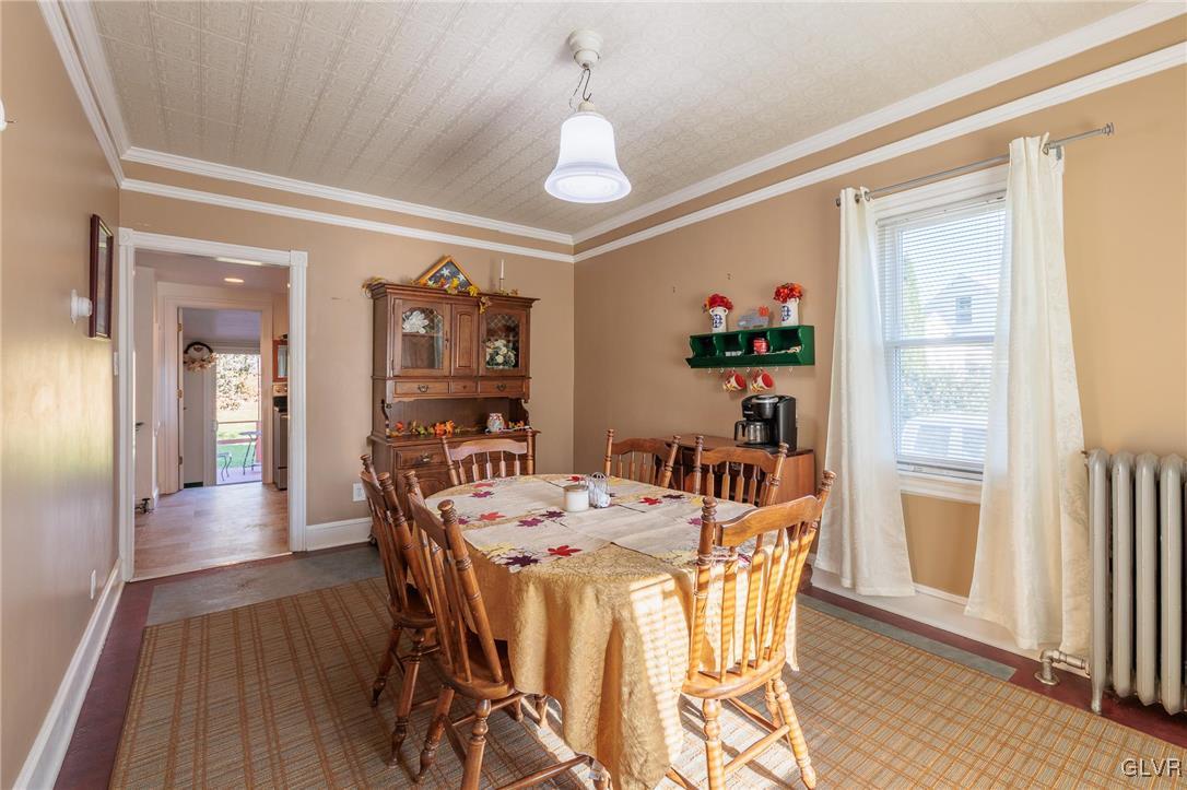 615 Alpha Road Wind Gap, PA 18091 - Photo 18 of 38 a dining room with furniture wooden floor a rug and a painting