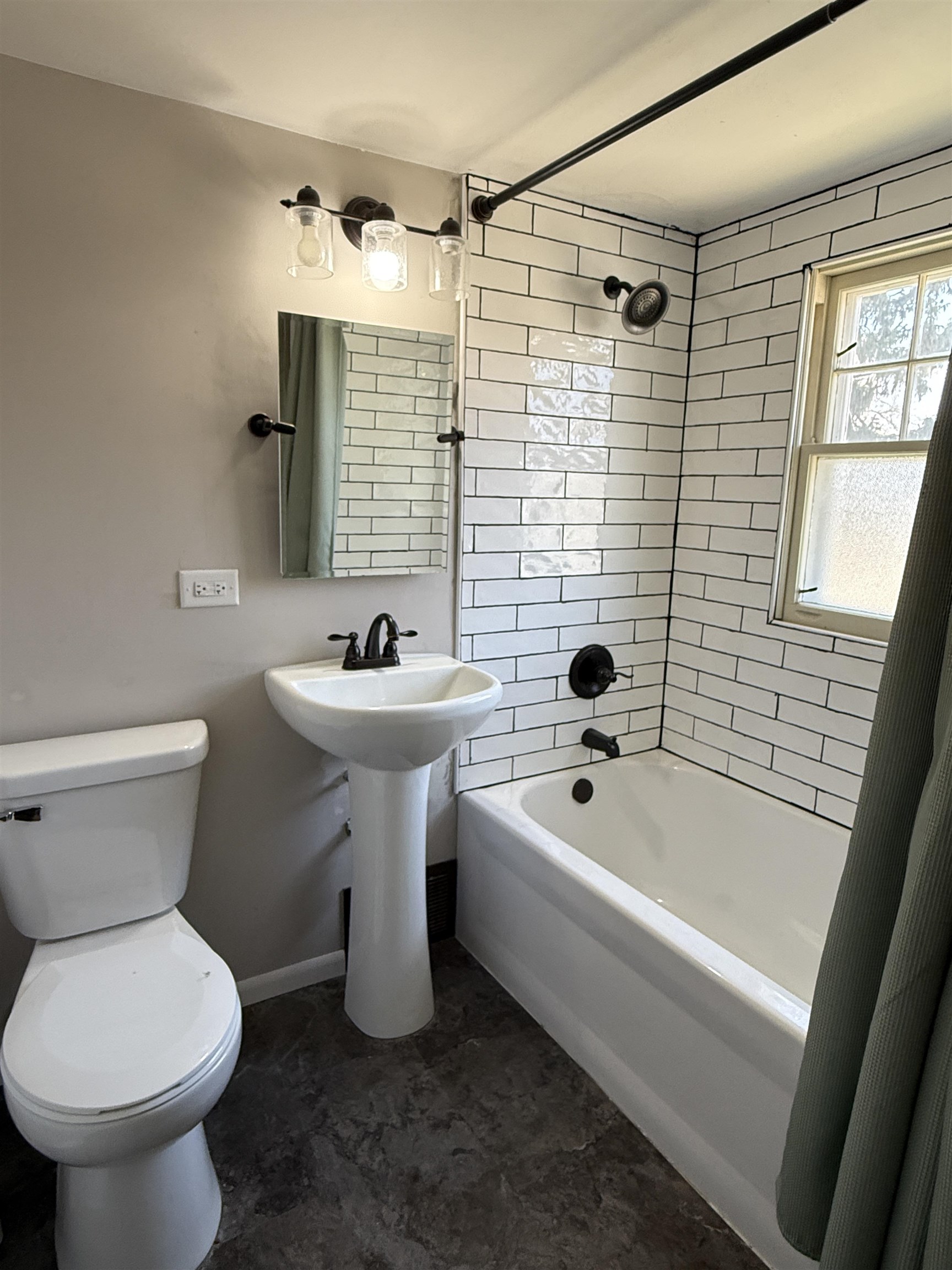 1038 North 8th Street Rochelle, IL 61068 - Photo 17 of 24 a bathroom with a sink a toilet and shower