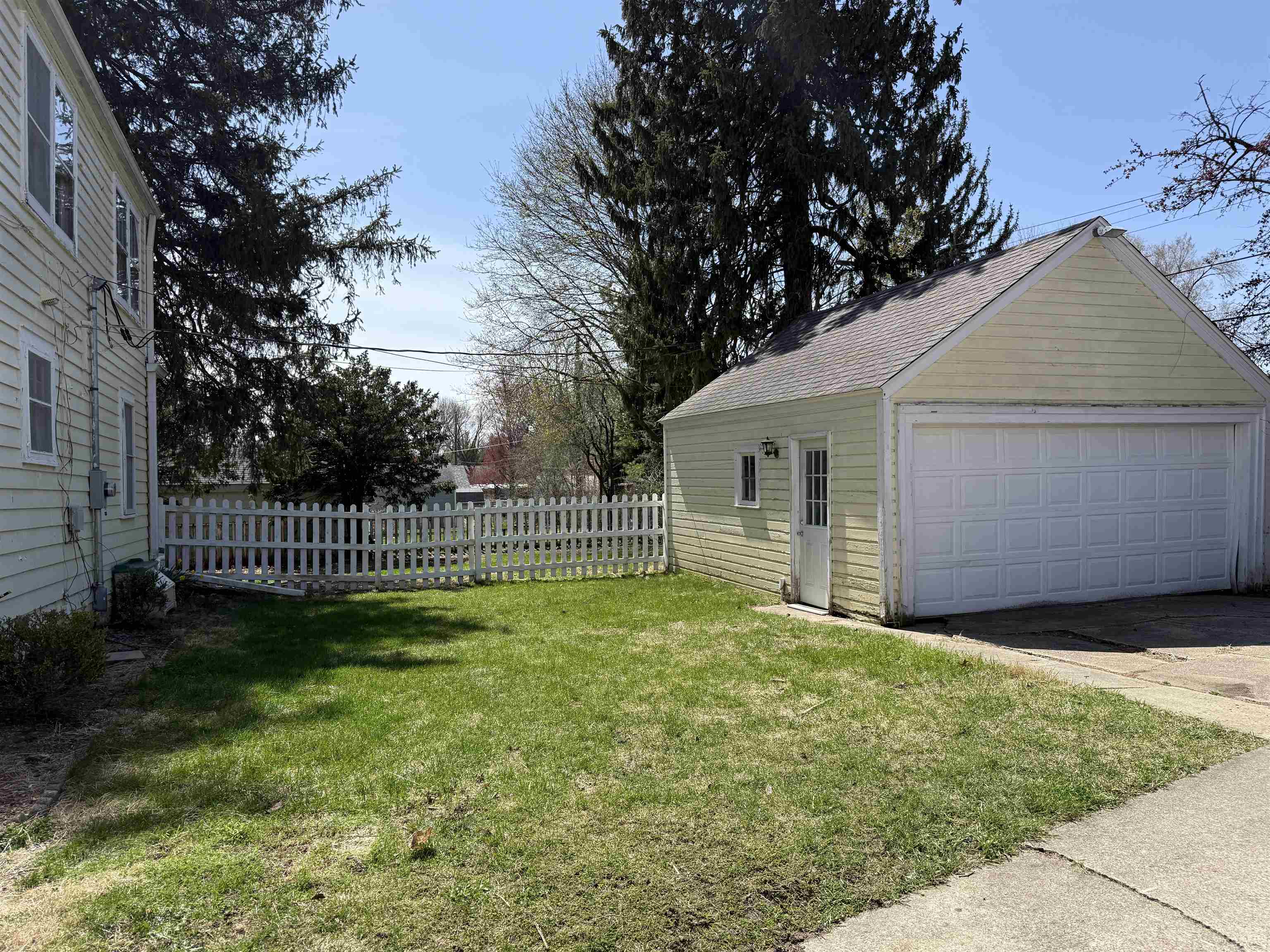 1038 North 8th Street Rochelle, IL 61068 - Photo 21 of 24 a view of a house with a small yard and a large tree