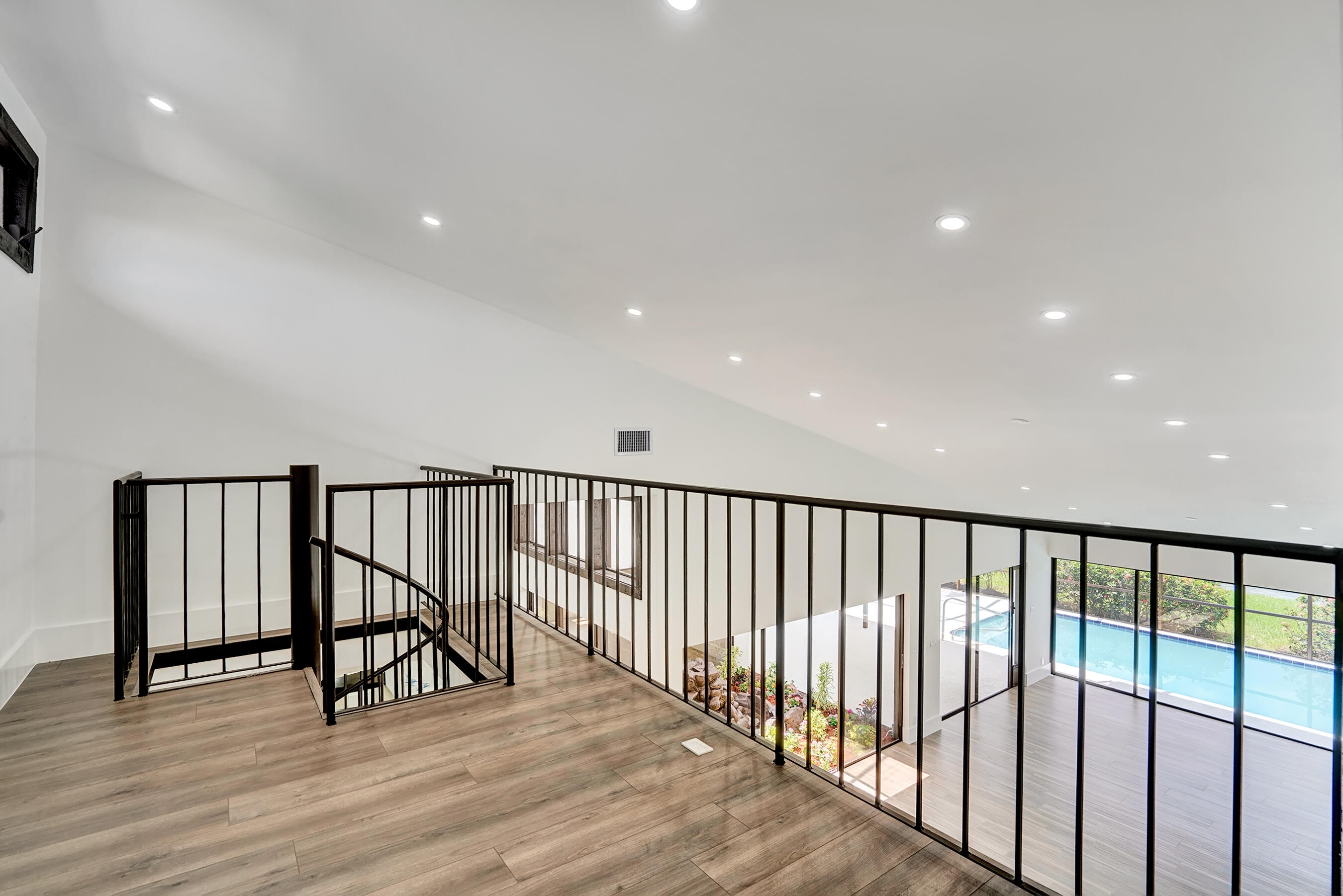 21075 Madria Circle Boca Raton, FL 33433 - Photo 15 of 29 a view of staircase with wooden floor and windows
