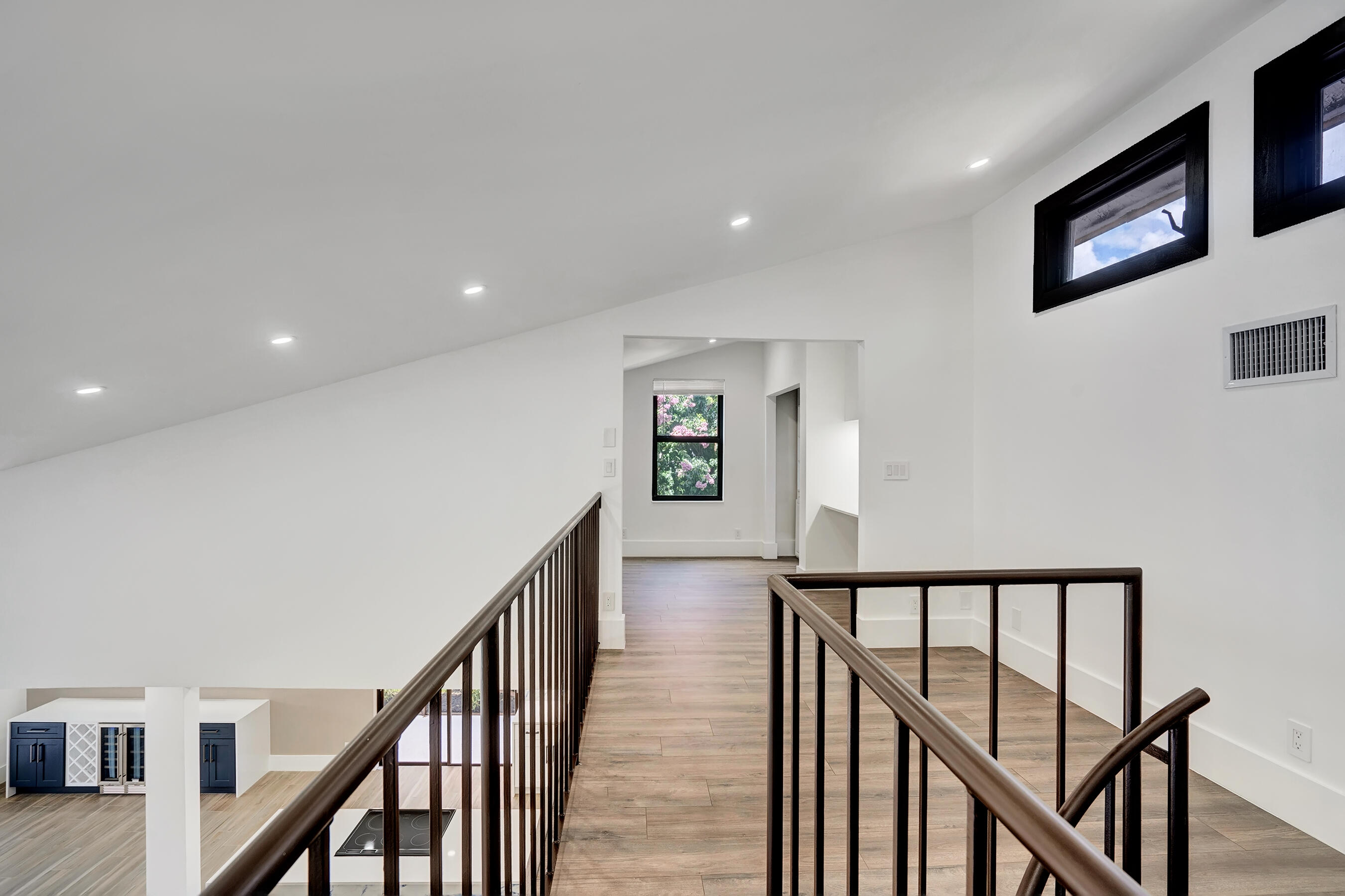 21075 Madria Circle Boca Raton, FL 33433 - Photo 16 of 29 a view of staircase with lots of frames on wall and wooden floor