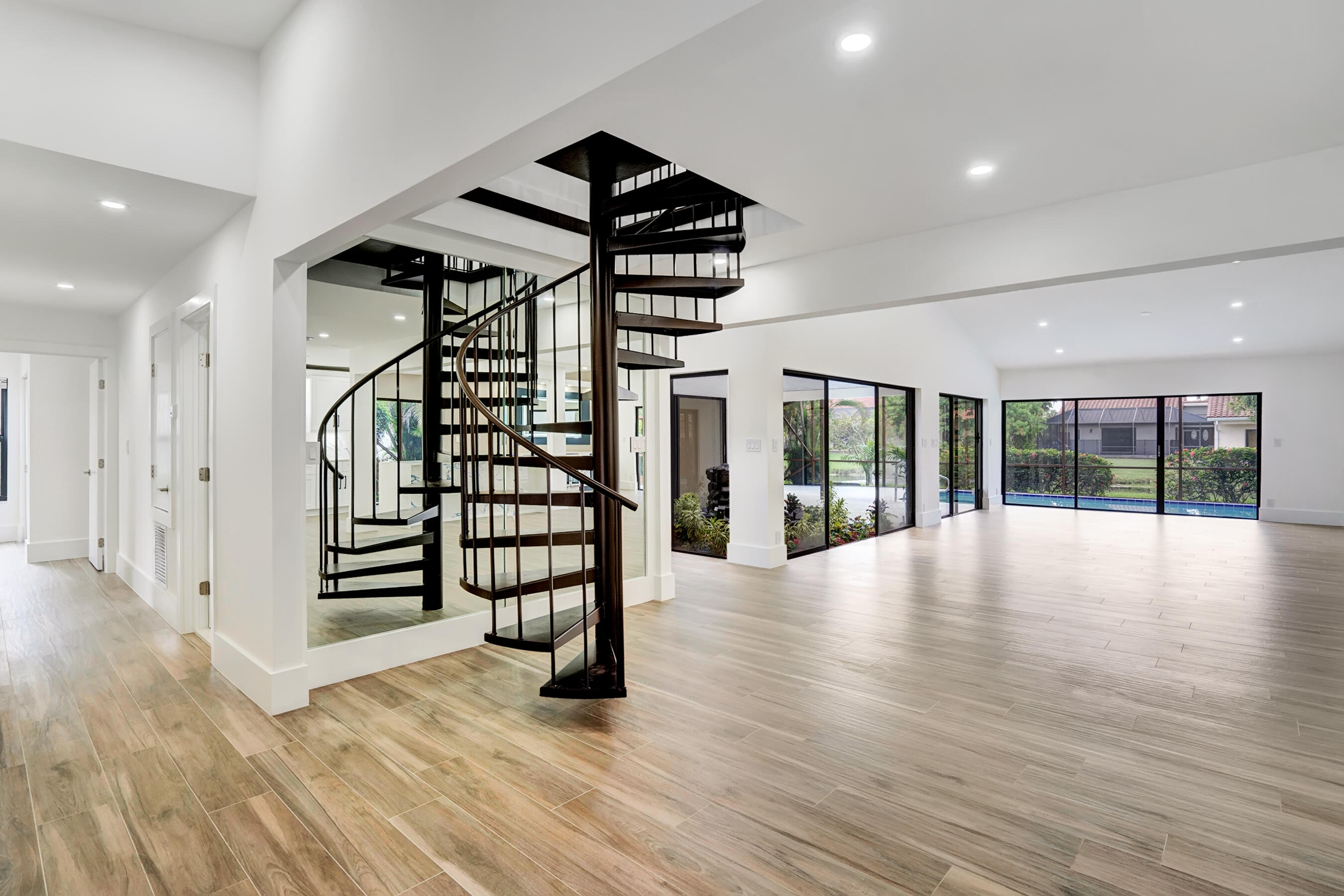 21075 Madria Circle Boca Raton, FL 33433 - Photo 2 of 29 a view of an empty room with wooden floor and windows