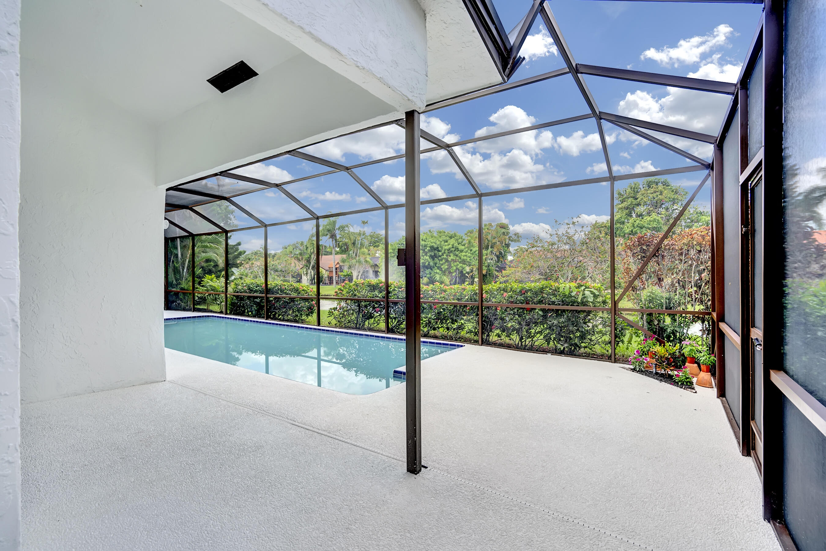 21075 Madria Circle Boca Raton, FL 33433 - Photo 23 of 29 a view of an empty room with a sliding door and wooden floor