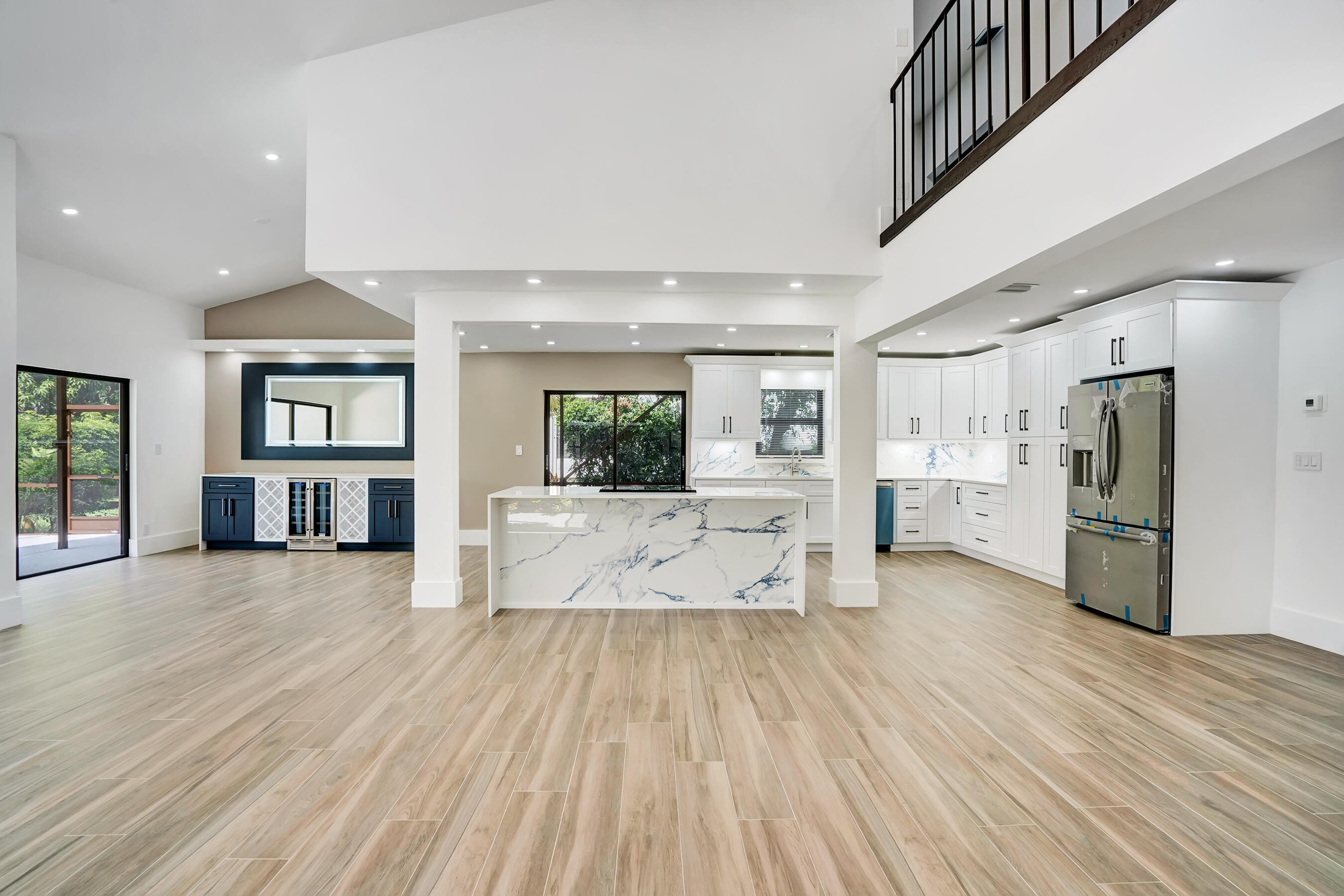 21075 Madria Circle Boca Raton, FL 33433 - Photo 4 of 29 a view of a living room kitchen with stainless steel appliances wooden floor and large windows