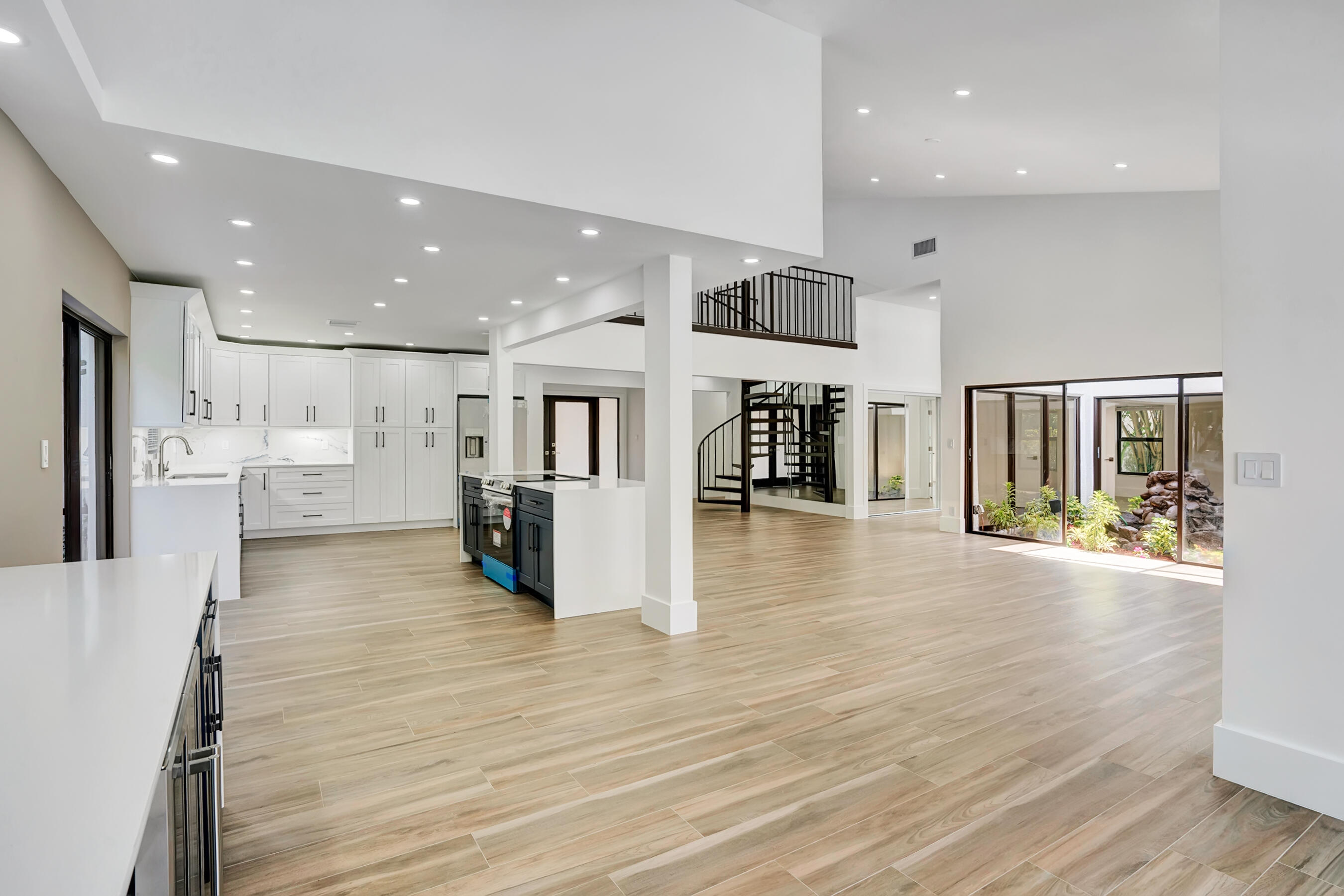 21075 Madria Circle Boca Raton, FL 33433 - Photo 5 of 29 a view of kitchen dining table chairs microwave and cabinets