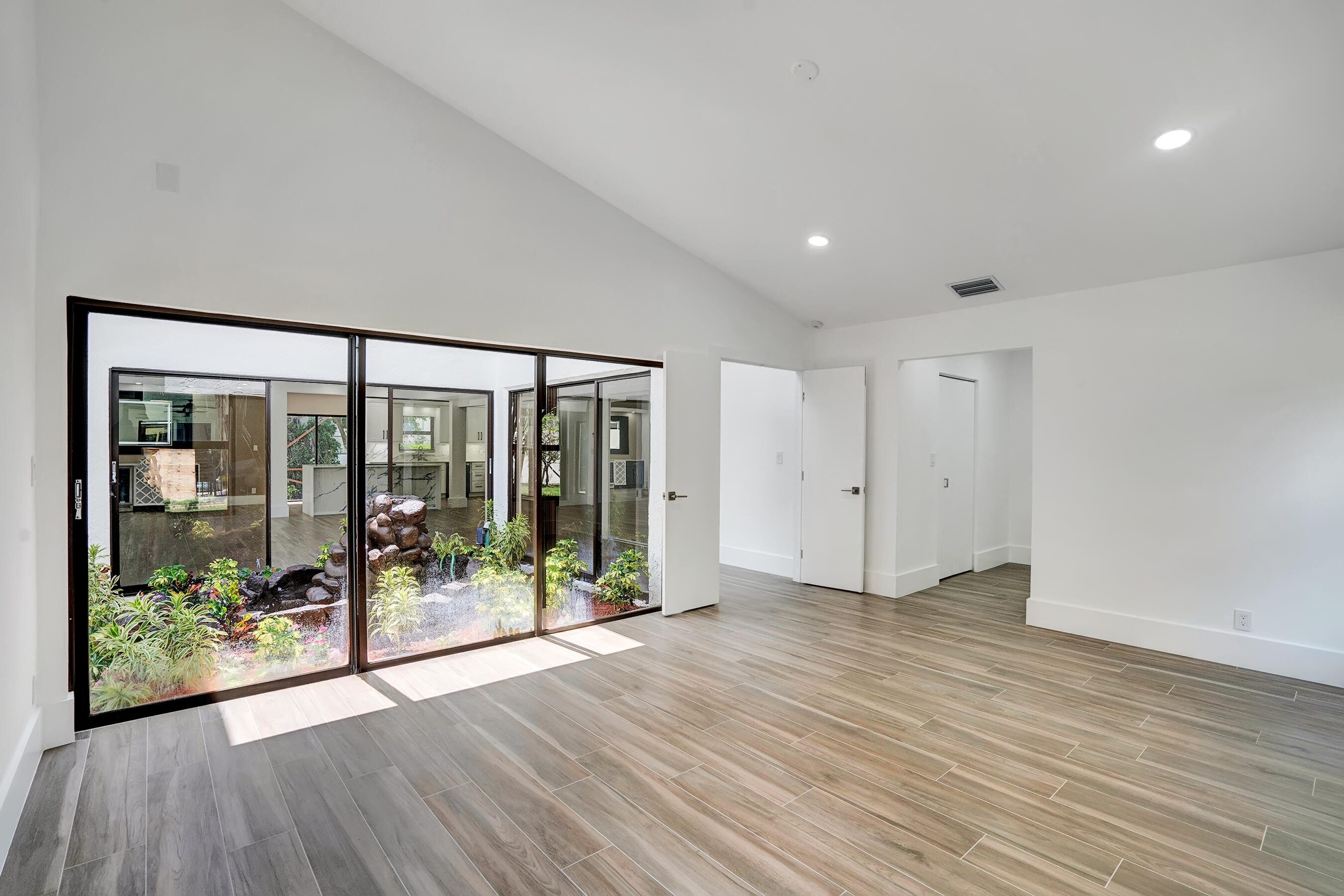 21075 Madria Circle Boca Raton, FL 33433 - Photo 10 of 29 a view of an empty room with wooden floor and a window