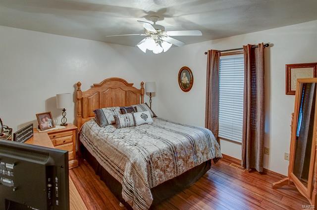 9514 State Route 143 Edwardsville, IL 62025 - Photo 12 of 29 a bedroom with a bed and a chandelier