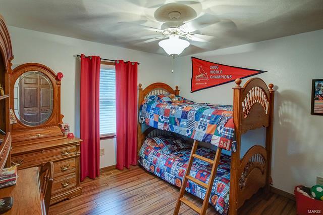 9514 State Route 143 Edwardsville, IL 62025 - Photo 13 of 29 a bedroom with a bed and a chandelier