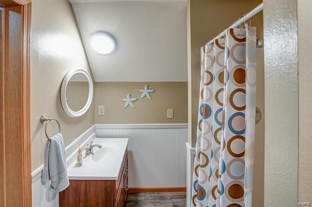 9514 State Route 143 Edwardsville, IL 62025 - Photo 15 of 29 a bathroom with a sink a mirror a light fixture and a mirror
