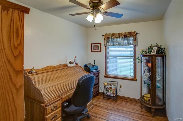 9514 State Route 143 Edwardsville, IL 62025 - Photo 17 of 29 a bedroom with a bed and a chandelier