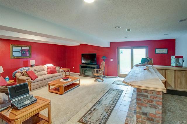 9514 State Route 143 Edwardsville, IL 62025 - Photo 18 of 29 a bedroom with furniture and a fireplace
