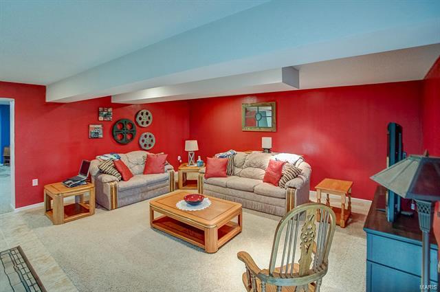 9514 State Route 143 Edwardsville, IL 62025 - Photo 19 of 29 a living room with furniture a rug and a projector