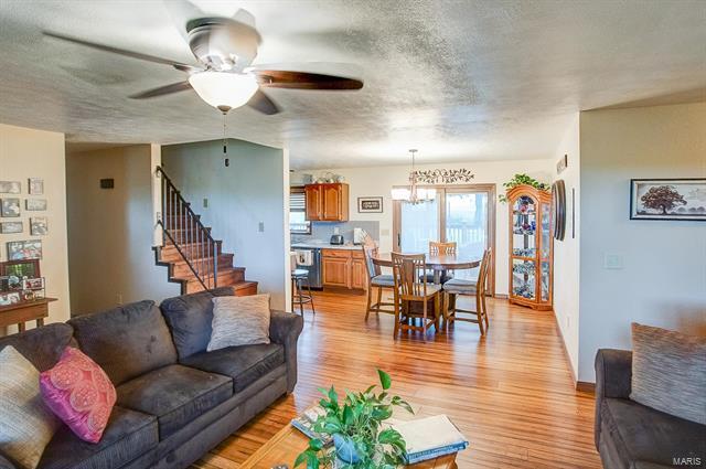 9514 State Route 143 Edwardsville, IL 62025 - Photo 3 of 29 a living room with furniture kitchen view and a wooden floor