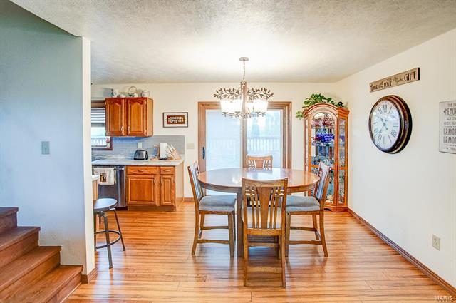 9514 State Route 143 Edwardsville, IL 62025 - Photo 4 of 29 a view of a dining room with furniture and wooden floor