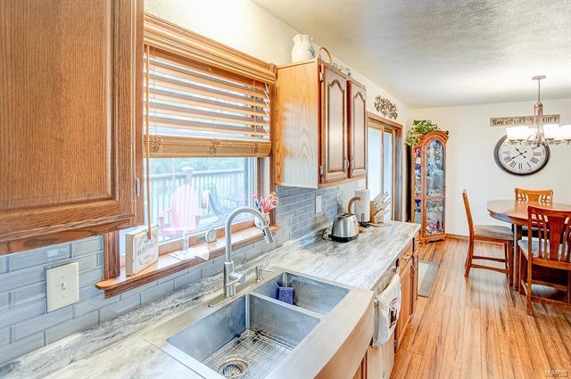 9514 State Route 143 Edwardsville, IL 62025 - Photo 6 of 29 a kitchen with granite countertop a sink and a window